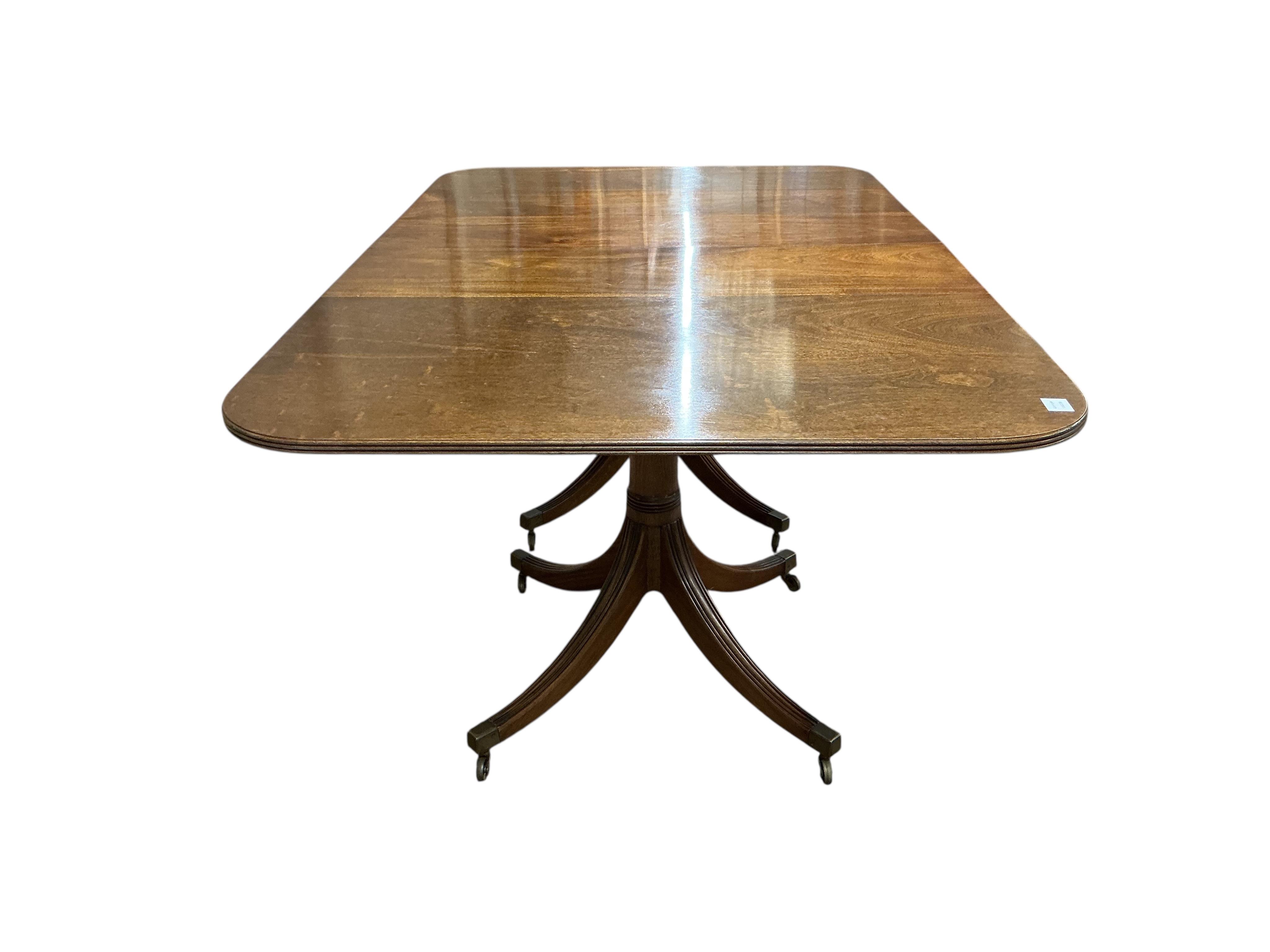 A Regency style mahogany twin pillar extending dining table, width 295cm extended, two spare leaves, depth 114cm, height 74cm